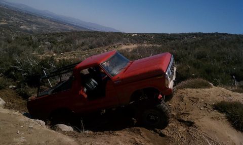 1978 Ford Bronco - This red 1978 Ford Bronco navigates a challenging off-road trail.