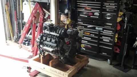 2008 Jeep Wrangler - Engine assembly on a wooden crate with a red engine hoist and a large black tool chest.
