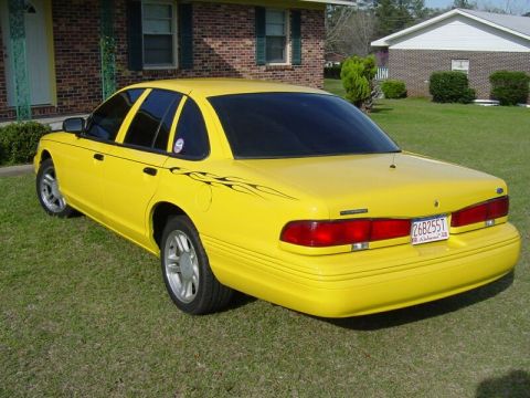 1998 Ford Crown Victoria - This 1998 Ford Crown Victoria features a bright yellow paint job, flame decals, and a custom license plate.