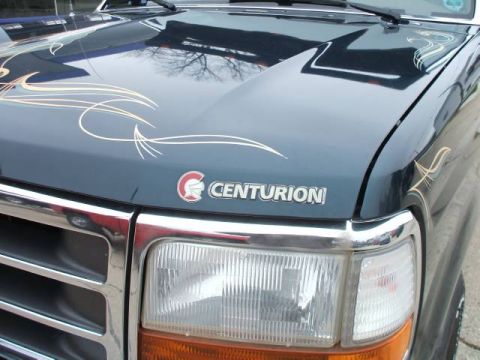 1999 Ford Ranger - A dark blue truck features chrome accents and pinstripe graphics on its hood, with a Centurion badge.