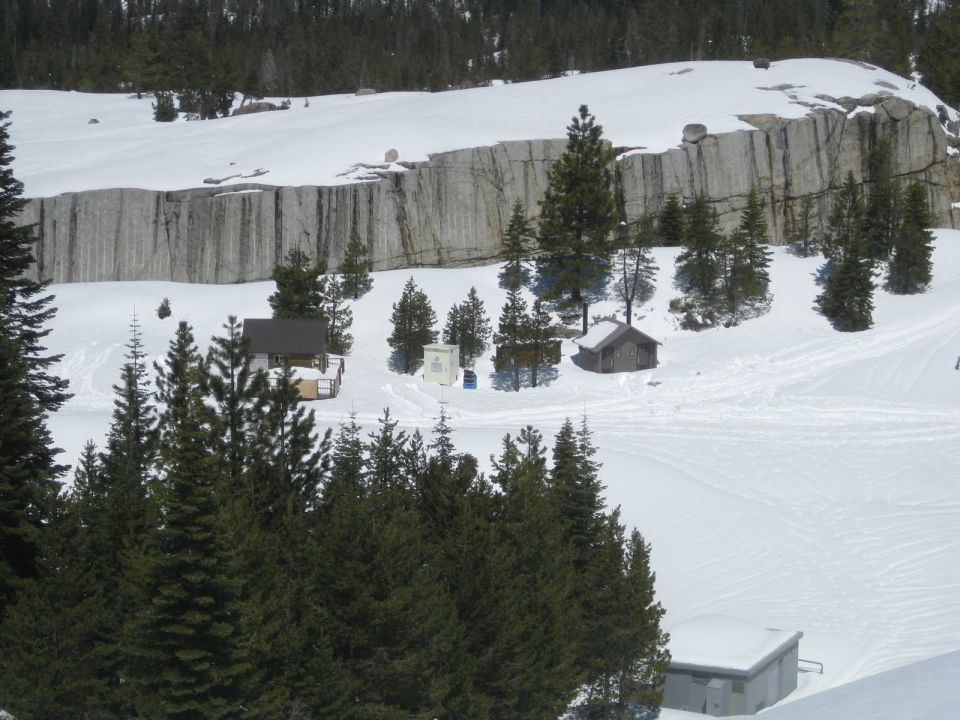 Snowy mountain landscape with trees and buildings