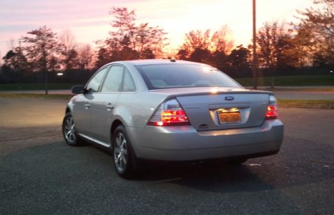 2008 Ford Taurus - Rear view of a silver 2008 Ford Taurus sedan parked on asphalt during sunset.