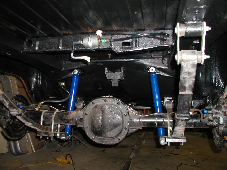 1960 Ford Ranchero rear axle, leaf springs, and blue shock absorbers