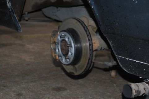 1975 Ford Ranchero - The rear brake system of a vehicle is shown, focusing on the rotor and caliper components.