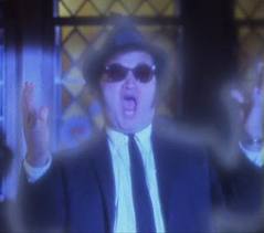 1991 Ford LTD Crown Victoria - A man in a hat and sunglasses appears to be singing or shouting, with text from SUPERMOTORS visible.