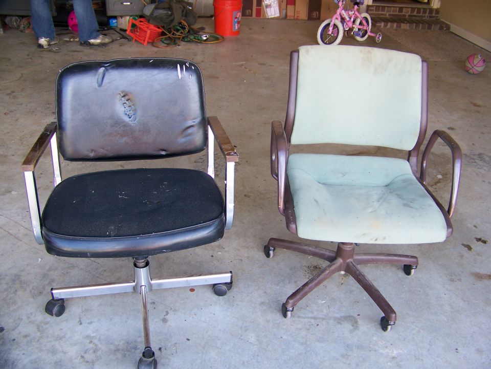 Two office chairs, one black with torn upholstery, the other light green and worn, sit on a concrete floor