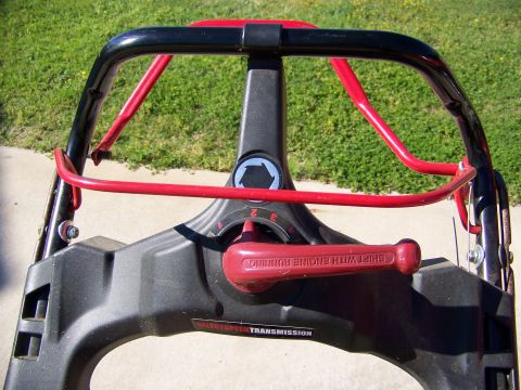2000 Jeep Wrangler - Close-up of a lawnmower's handle and control panel, a red shift lever and transmission settings.