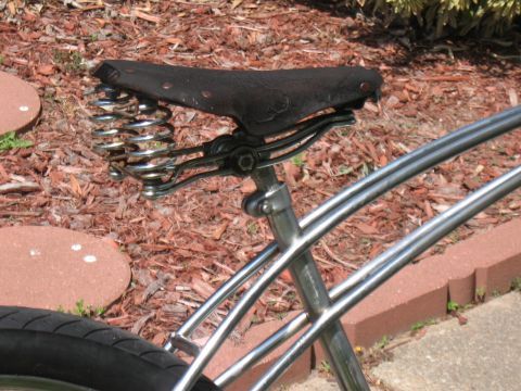 1994 Ford Bronco - A close-up view of a vintage-style bicycle seat a black leather top and chrome springs.