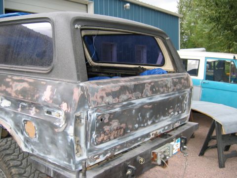 1978 Ford Bronco - This 1978 Ford Bronco is in the process of body repair, with primer and exposed metal visible on its rear.