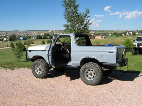 1978 Ford Bronco - A 1978 Ford Bronco sits in a driveway with a suburban landscape in the background.