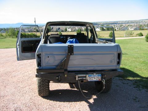 1978 Ford Bronco - This 1978 Ford Bronco is shown from the rear with its doors open and a spare tire carrier mounted on the tailgate.