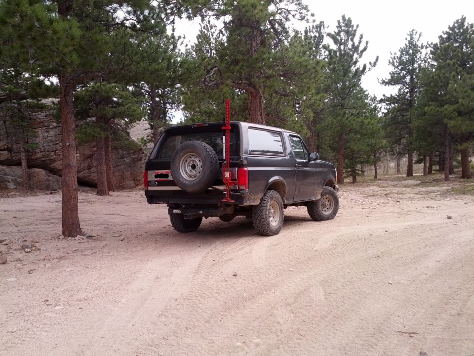 Black 1994 Ford Bronco rear view with spare tire on tailgate