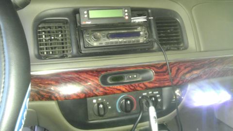2000 Mercury Grand Marquis - The interior dashboard of a 2000 Mercury Grand Marquis shows an aftermarket stereo and digital display unit.