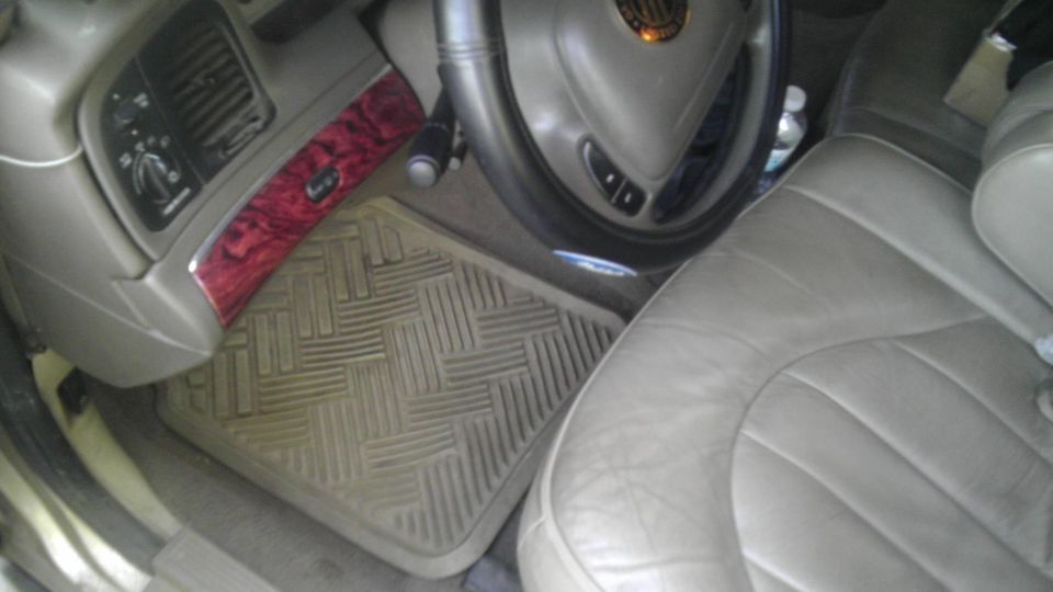 2000 Mercury Grand Marquis interior showing driver's side dashboard, floor mat, and leather seat