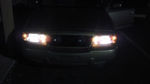 2000 Mercury Grand Marquis - Front view of a 2000 Mercury Grand Marquis at night with headlights illuminated.