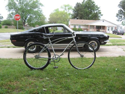 1994 Ford Bronco - A silver cruiser bicycle is parked in front of a black 1967 Ford Mustang Shelby GT500.