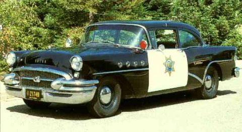 1991 Ford Crown Victoria - This vintage police car, a Buick Century, is shown in a three-quarter front view with its distinctive two-tone paint scheme.