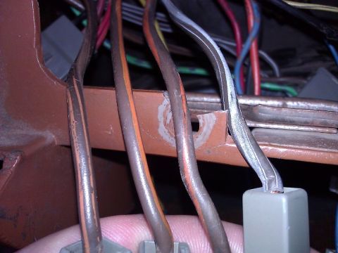 1981 Ford Bronco - A close-up view of a vehicle's electrical wiring harness, showing multiple colored wires and connectors.