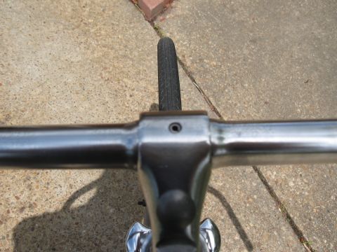 1994 Ford Bronco - Close-up view of bicycle handlebars and a tire against a concrete background.