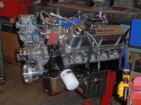 1990 Ford Bronco - Engine assembly with chrome accents and visible oil filter, mounted on a stand.