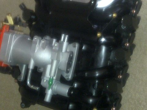 2000 Ford Crown Victoria - This is a close-up view of an engine intake manifold, likely a replacement part.