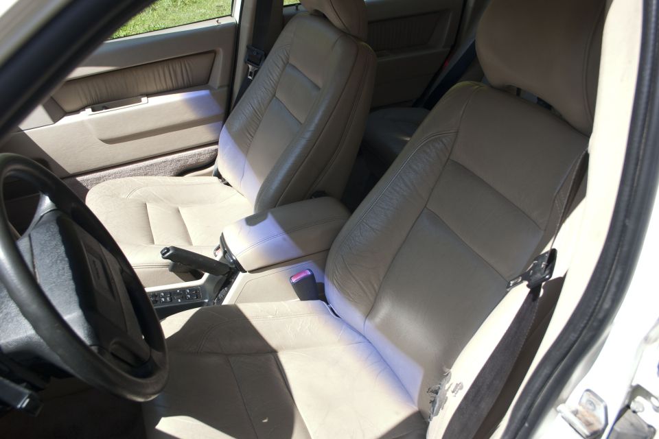 Interior view of car seats, dashboard, and steering wheel