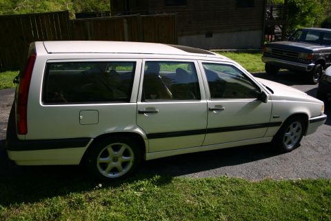 1997 Volvo 850 - A white 1997 Volvo 850 wagon is parked in a driveway next to another vehicle.