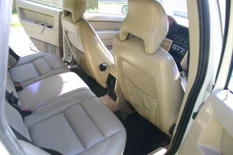 1997 Volvo 850 - The interior of a car shows the rear seats and door panel, with a view towards the dashboard.