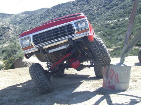 1978 Ford Bronco - 1978 Ford Bronco navigating a challenging off-road course, demonstrating its suspension articulation.
