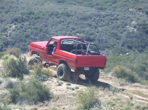 1978 Ford Bronco - 1978 Ford Bronco navigating rough terrain on a sunny day.
