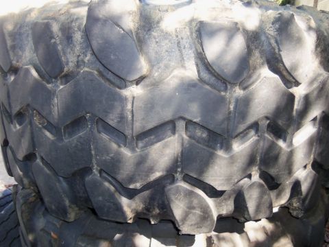 1968 Ford Bronco - A close-up view of a tire's tread pattern, showing significant wear and a chevron design.