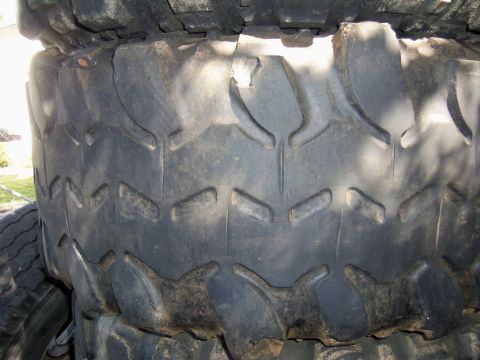 1968 Ford Bronco - Close-up view of stacked off-road tires, showing their deep tread for traction.