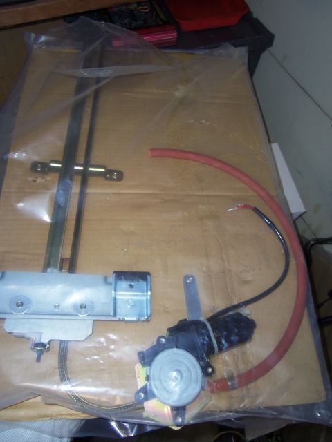 1968 Ford Bronco - A close-up view of a vehicle window regulator and motor assembly, likely for sale.