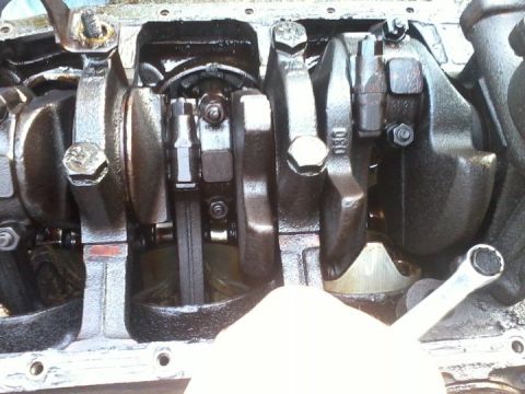 1989 Ford Bronco - Close-up view of an engine's crankshaft and connecting rods, with some visible markings.