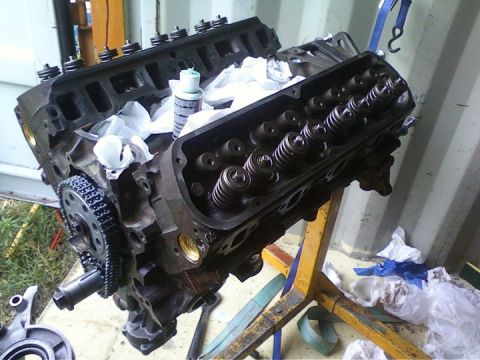 1989 Ford Bronco - Engine block on an engine stand, with valve covers removed to expose the valve train components.
