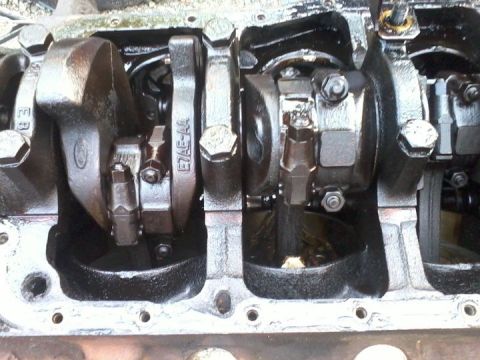 1989 Ford Bronco - Close-up view of engine crankshaft and connecting rods, showing a Ford logo.