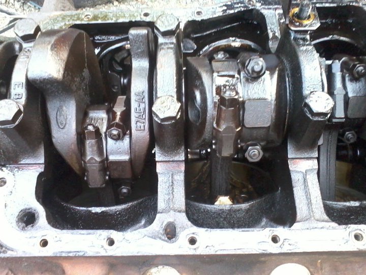 Engine crankshaft and connecting rods with Ford logo visible