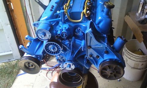 1989 Ford Bronco - A blue engine block with various pulleys and hoses is shown. The Supermotors logo is visible in the lower right corner.