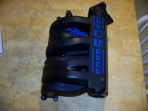 1989 Ford Bronco - Ford 5.0 EFI intake manifold shown on a wooden table.