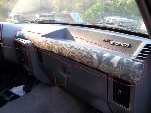 1989 Ford Bronco - The interior of a 1989 Ford Bronco features a camouflage-covered dashboard trim and an XLT Bronco badge.