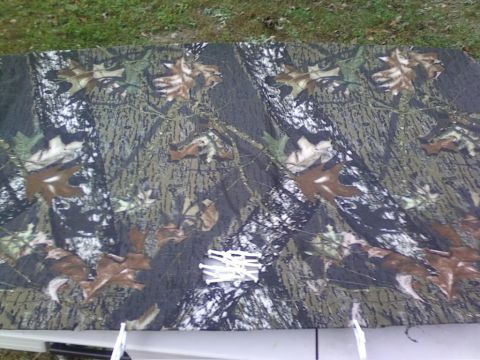 1989 Ford Bronco - A piece of camouflage fabric with a leaf pattern is shown outdoors.