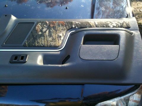 1989 Ford Bronco - Door panel with camouflage insert, likely from an older SUV or truck.
