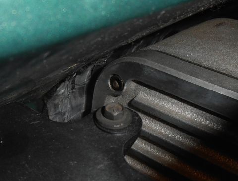 1990 Ford Bronco - Detail of an engine component, showing bolted connections and textured surfaces.