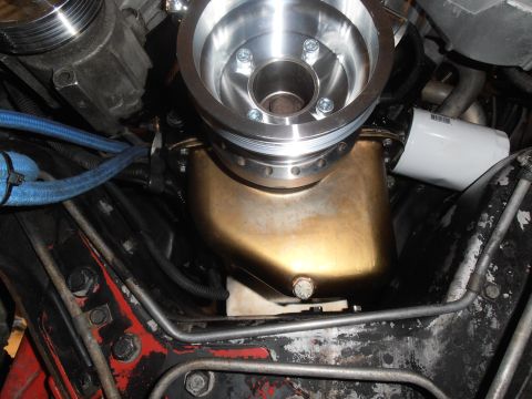1990 Ford Bronco - Close-up view of an engine's oil pan and pulley system, with a white oil filter visible.
