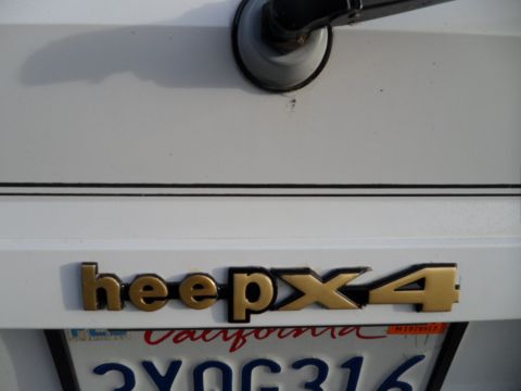 1994 Jeep Cherokee - Rear view of a 1994 Jeep Cherokee showing the 'Jeep 4x4' badge and California license plate.