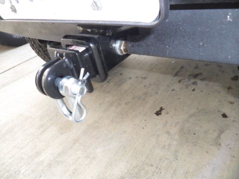 1994 Jeep Cherokee - Close-up of a trailer hitch receiver mounted on a vehicle's frame, showing the pin and clip mechanism.