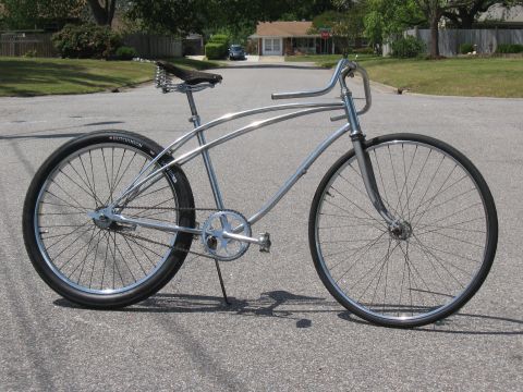 1994 Ford Bronco - A custom cruiser bicycle with a chrome frame and vintage-style saddle is parked on a suburban street.