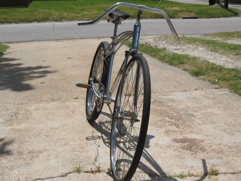 1994 Ford Bronco - A custom bicycle with chrome accents and wide handlebars is parked on a concrete surface.