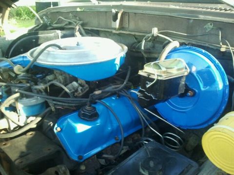 1979 Ford Bronco - Close-up of an engine bay, showing various components and blue painted parts.