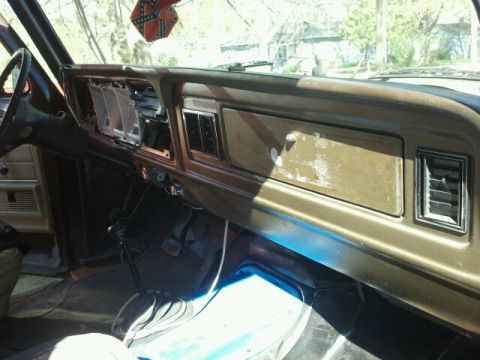 1979 Ford Bronco - The interior of a classic Ford Bronco shows its dashboard with visible wear and tear.